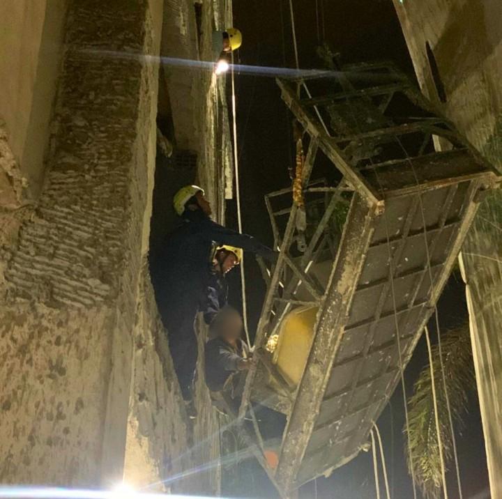 Trabalhador sendo resgatado em um andaime suspenso por bombeiros